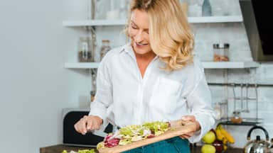 Frau in den Wechseljahren kocht