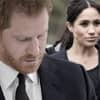 Prinz Harry guckt traurig, Herzogin Meghan guckt ernst