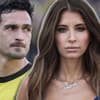 Cathy Hummels guckt ernst in die Kamera, hinter ihr steht Mats Hummels mit traurigem Blick