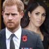 Prinz Harry sieht ernst aus, Herzogin Meghan lächelt im Hintergrund