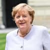 Angela Merkel guckt zur Seite und lacht