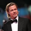 Brad Pitt lächelt und trägt einen Anzug