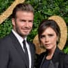 David und Victoria Beckham posieren vor grüner Wand