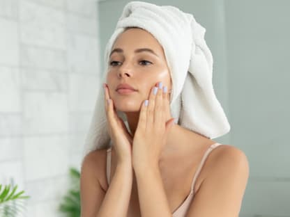 Frau pflegt Haut mit Peeling-Serum