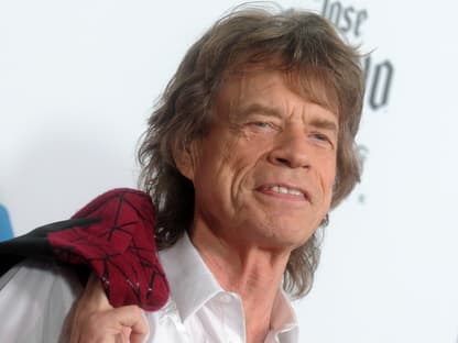 Mick Jagger grinst auf dem roten Teppich