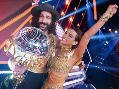 Massimo und Lili Paul-Roncalli lächeln in die Kamera und halten den Let's Dance Gewinner Pokal.