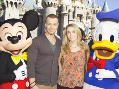 Bitte lächeln! Melissa Joan Hart und Joey Lawrence posieren vor dem großen Disney-Schloss mit Mickey Mouse und Donald Duck